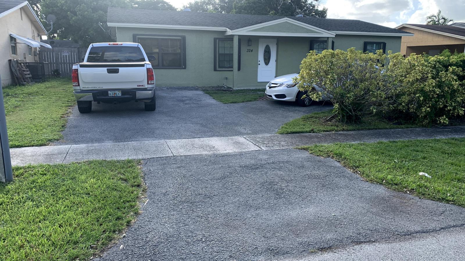 Driveway before — cracked asphalt